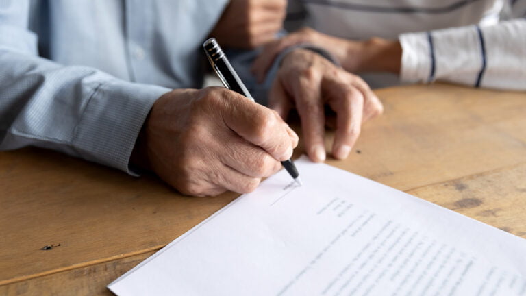 older person signing a Will